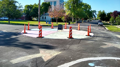 A traffic circle, crosswalks, sharrows, and curb extensions in Provo, UT using cornstarch paint and vertical panels (BikeWalk Provo)